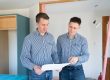 Kane and Ronan from My New Start reviewing plans in a Christchurch home