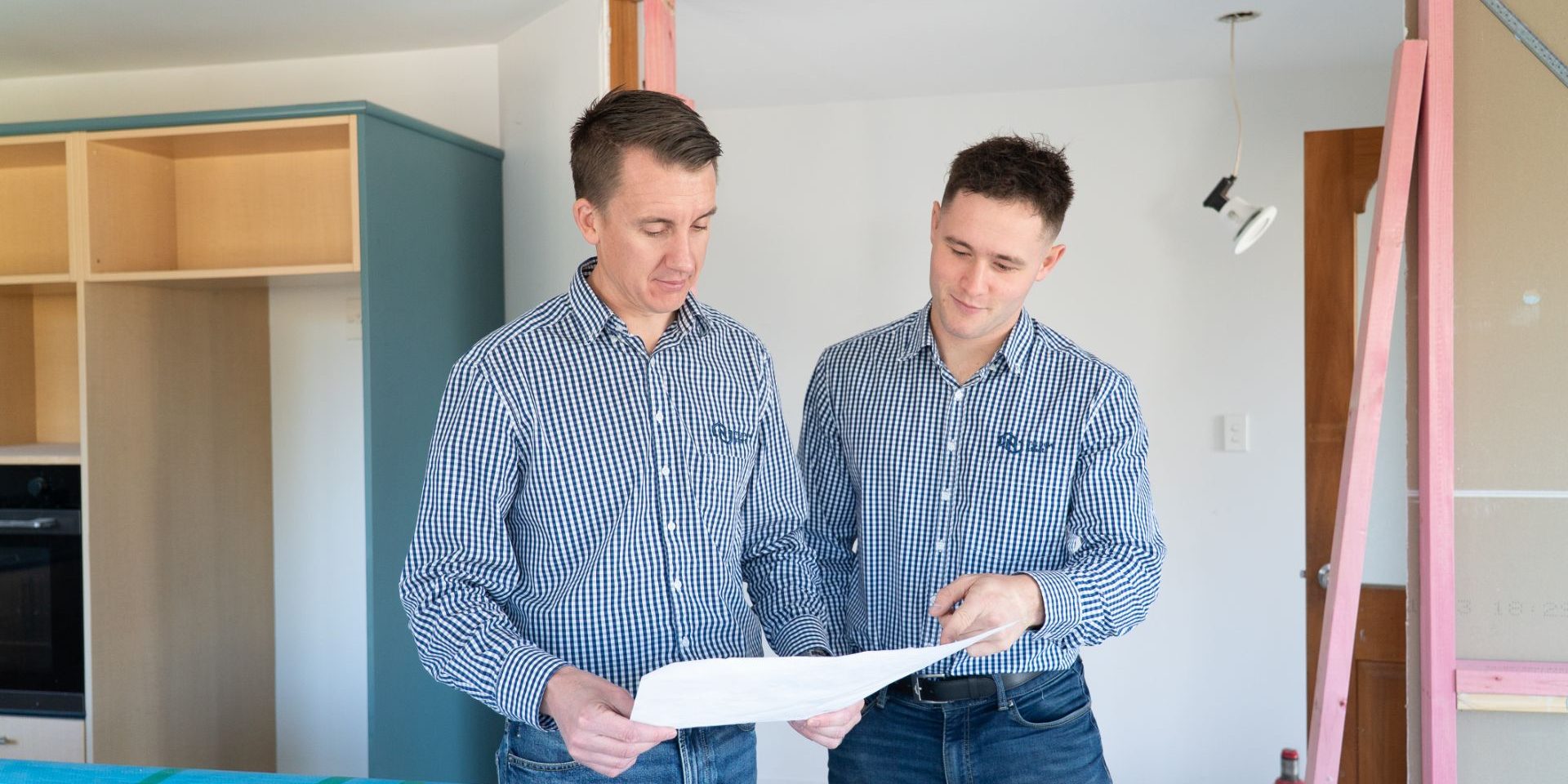 Kane and Ronan from My New Start reviewing plans in a Christchurch home